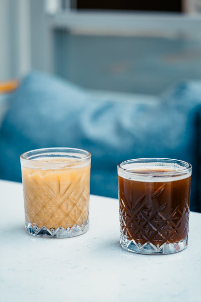 Aesthetic shot of iced latte and cold brew in crystal glasses on a bright day, outdoors in Ünye, Türkiye.